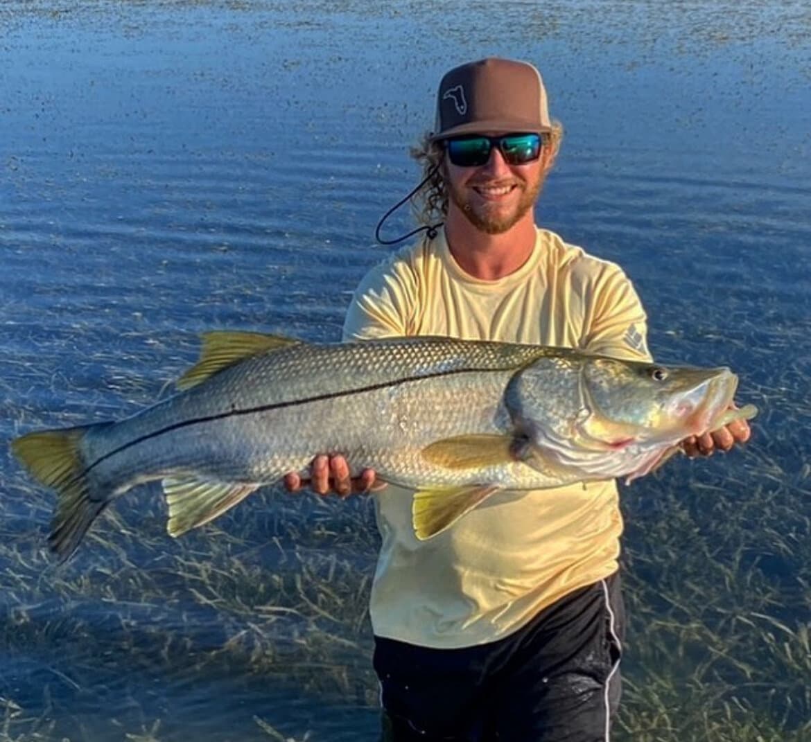 Captain Aaron with a tarpon catch on a New Port Richey fishing charter